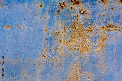 Peeling paint on rusty metal plate