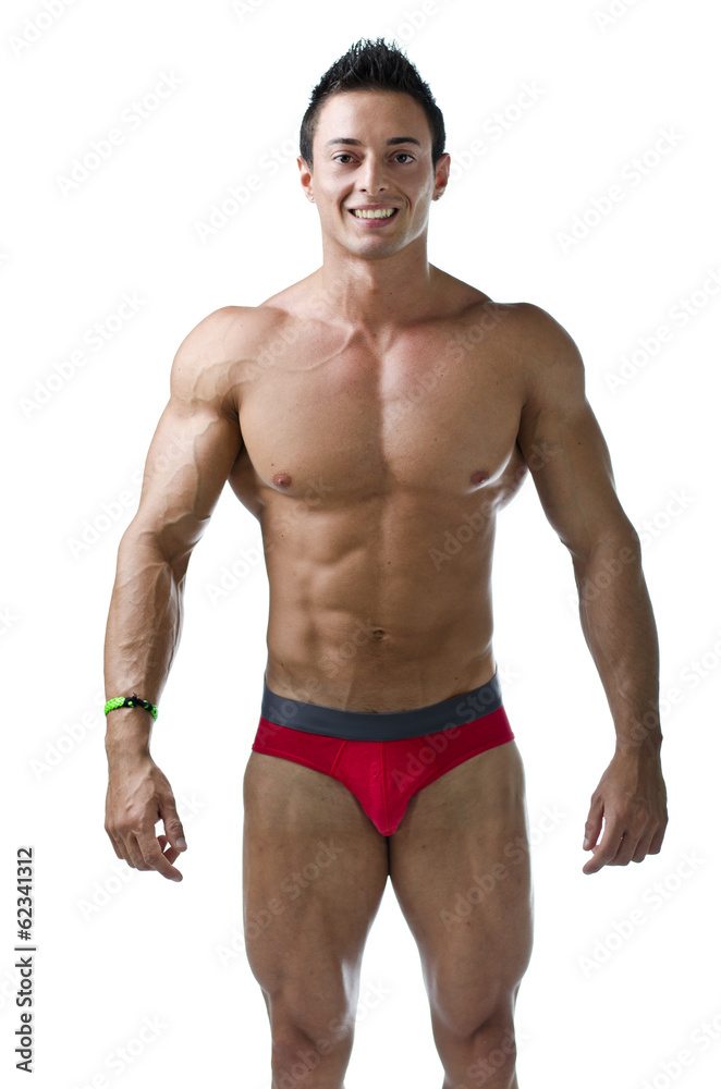 Muscular young bodybuilder in relaxed pose, smiling Muscular young bodybuilder in relaxed pose, smiling