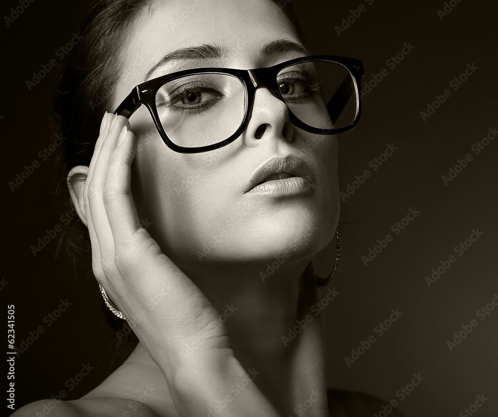 Fototapeta premium Sexy woman in glasses looking hot. Black and white portrait
