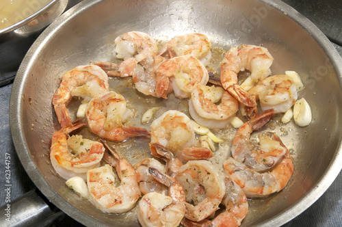 cooking shrimp in a pan in the kitchen at the restaurant
