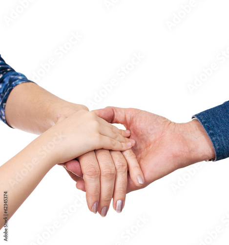hands of man, woman and girl together