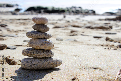 zen balance stone on the beach paradise