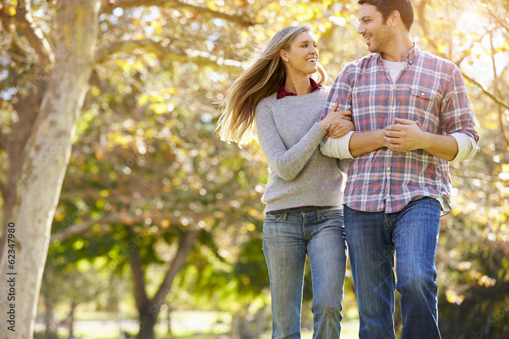 Romantic Couple Walking Through Autumn Woodland