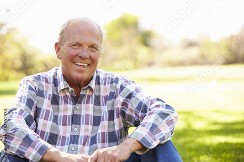 Senior Man Relaxing In Autumn Landscape