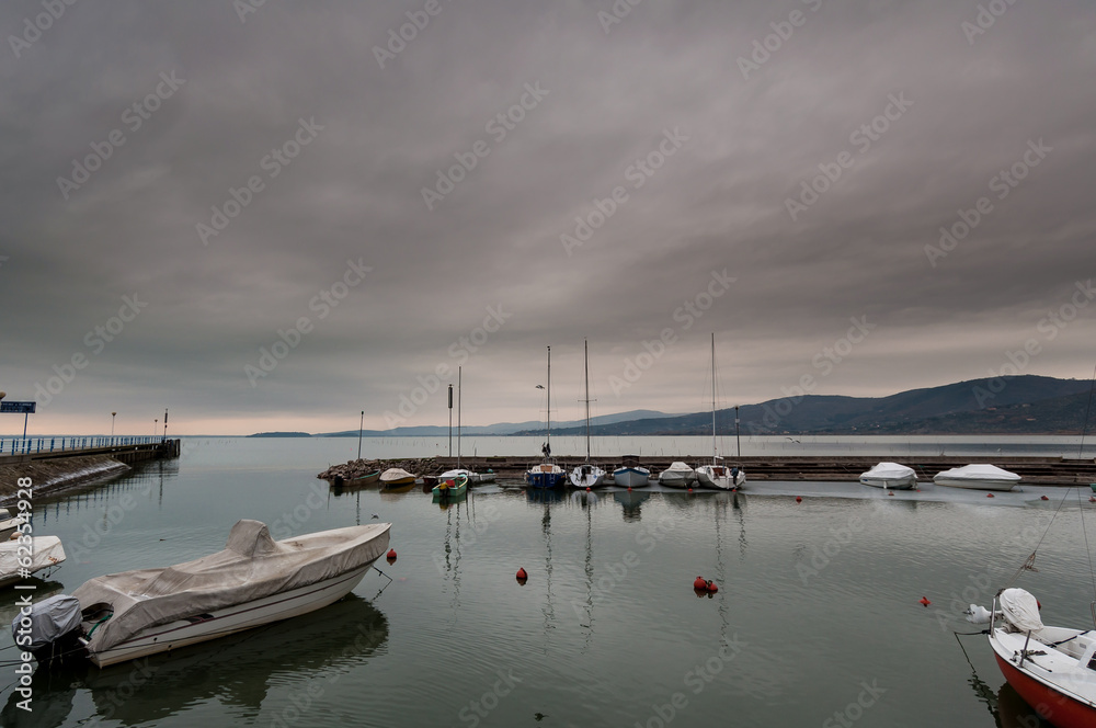 Boats on the pier at Trasimeno lake Boats on the pier at Trasimeno lake
