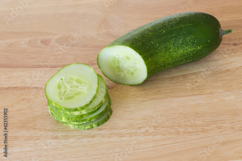 cucumber slices on wooden background