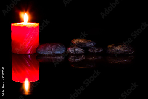 Canvas Print zen stones and aromatic candles on dark background.