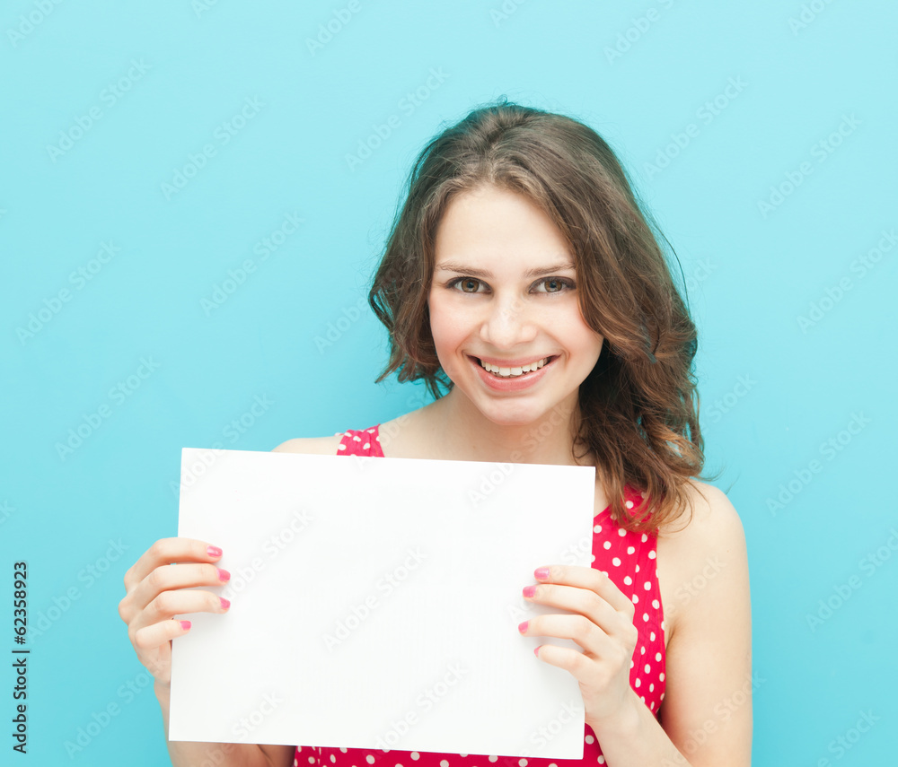 beautiful girl with a white sheet of paper on a blue background beautiful girl with a white sheet of paper on a blue background