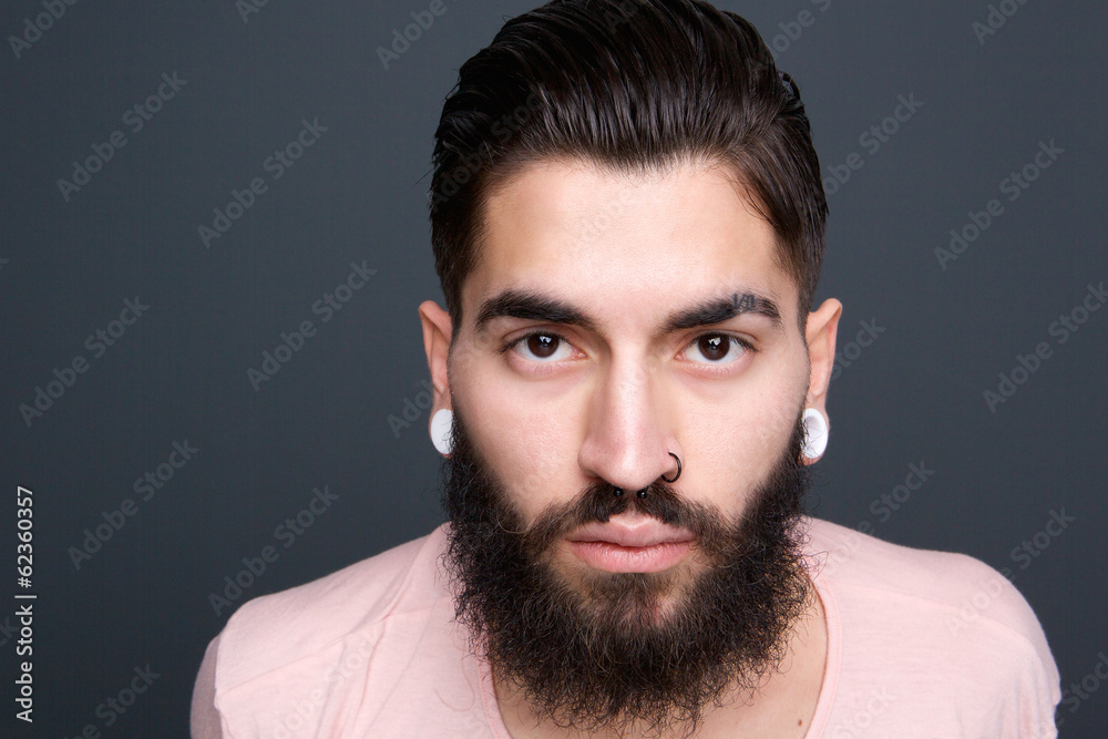 Fototapeta premium Young guy with beard and piercing