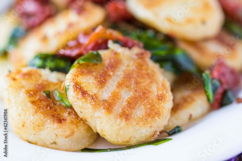 Fried potato gnocchi with sauce of dried tomatoes, spinach