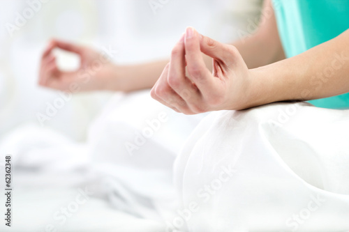 Close up portrait of a young woman in lotus position