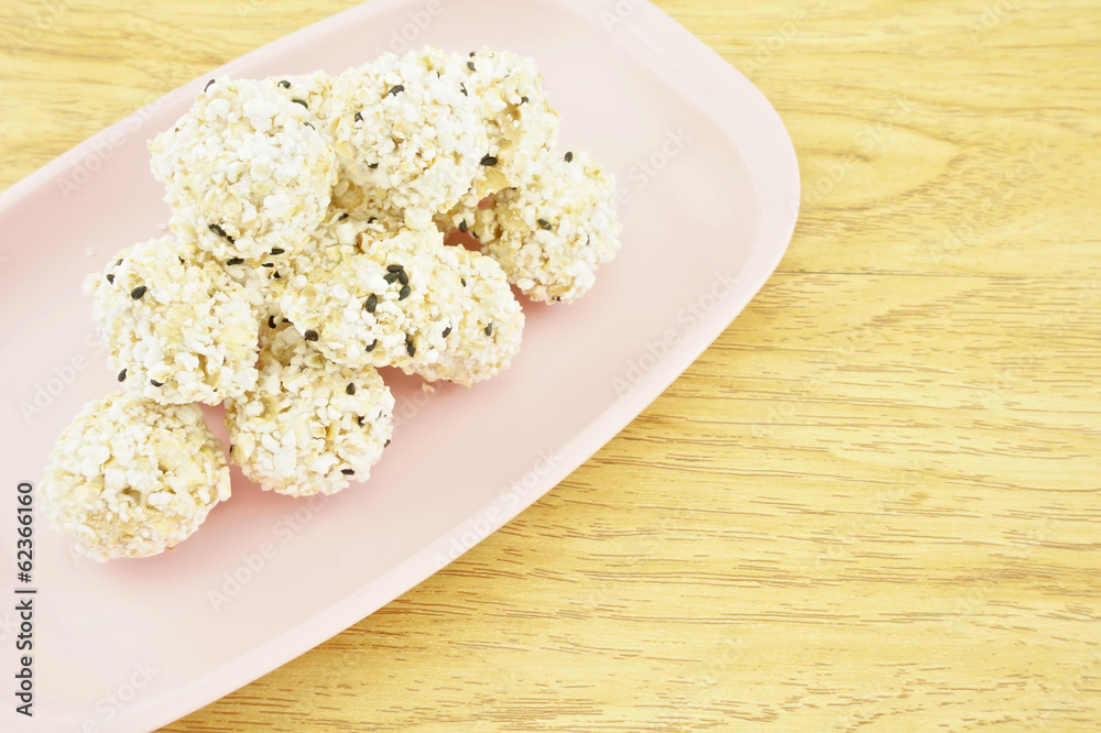 Popped rice mix black sesame on tray with wood background Popped rice mix black sesame on tray with wood background