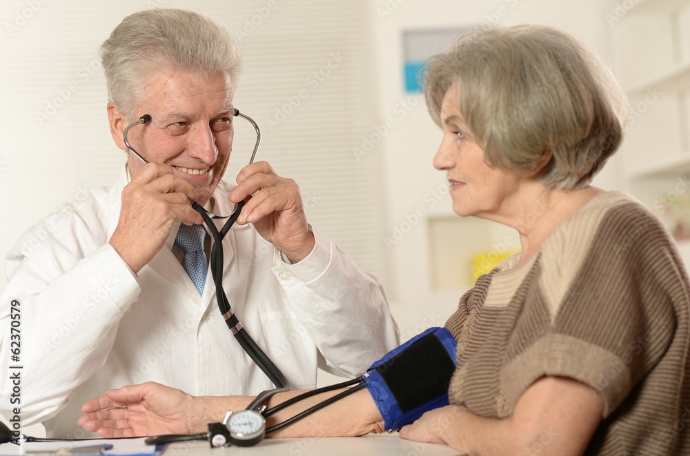 Caucasian aged doctor with a elderly patient Caucasian aged doctor with a elderly patient