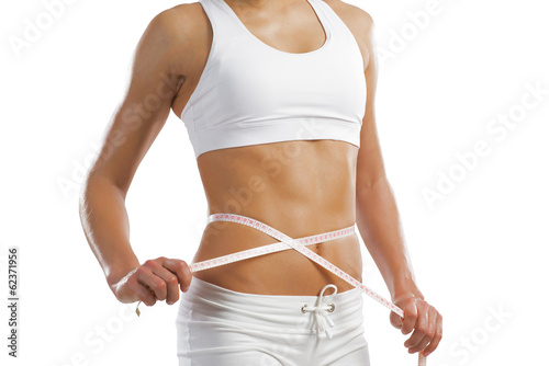 young athletic woman measuring waist