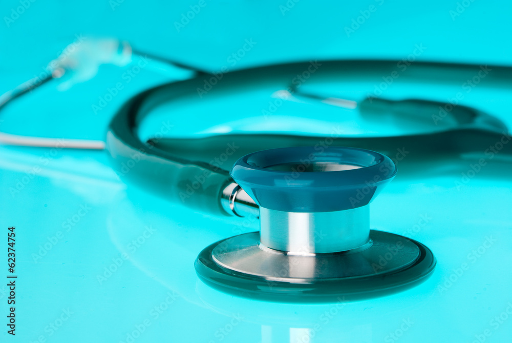 Stethoscope on blue, reflective background Stethoscope on blue, reflective background