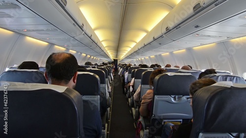 Interior of airplane with passengers on seats