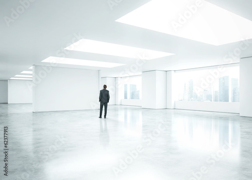 businessman standing in bright office