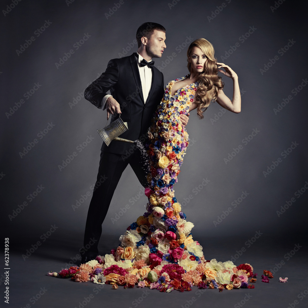 Young man and beautiful lady in flower dress - obrazy, fototapety, plakaty 