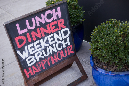 restaurant sign on sidewalk