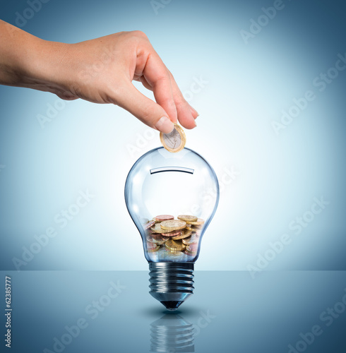 Fototapet invest to energy concept - euro in bulb - piggybank