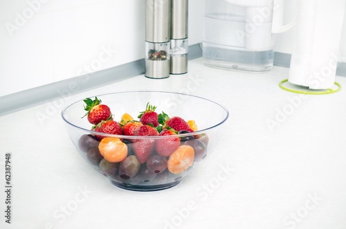 Glass bowl full of fruit in a modern kitchen