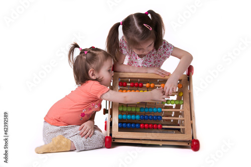Wallpaper Mural two girls playing with colored bills sitting Torontodigital.ca