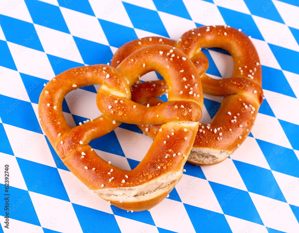 Two pretzel in heart shape on white blue background Two pretzel in heart shape on white blue background