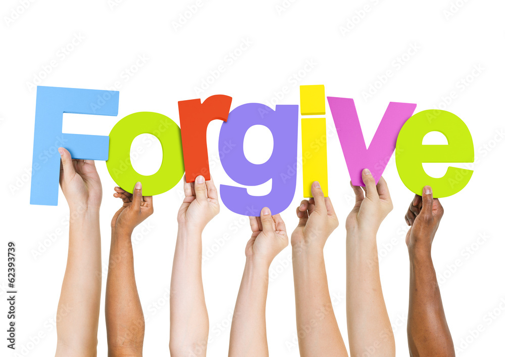 Multi-Ethnic Group of Diverse People Holding The Word Forgive Multi-Ethnic Group of Diverse People Holding The Word Forgive