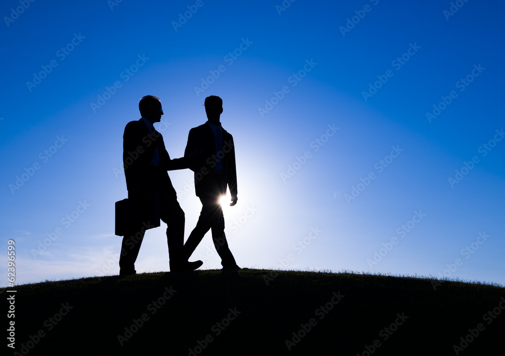 Two Businessman Discussing During Sunset
