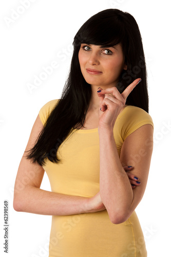 Beautiful young woman shows index finger as sign for being naugh