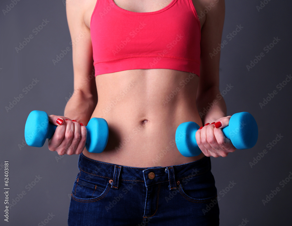 Young beautiful fitness girl exercising with dumbbells, Young beautiful fitness girl exercising with dumbbells,