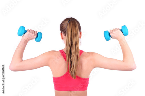 Young beautiful fitness girl exercising with dumbbells,