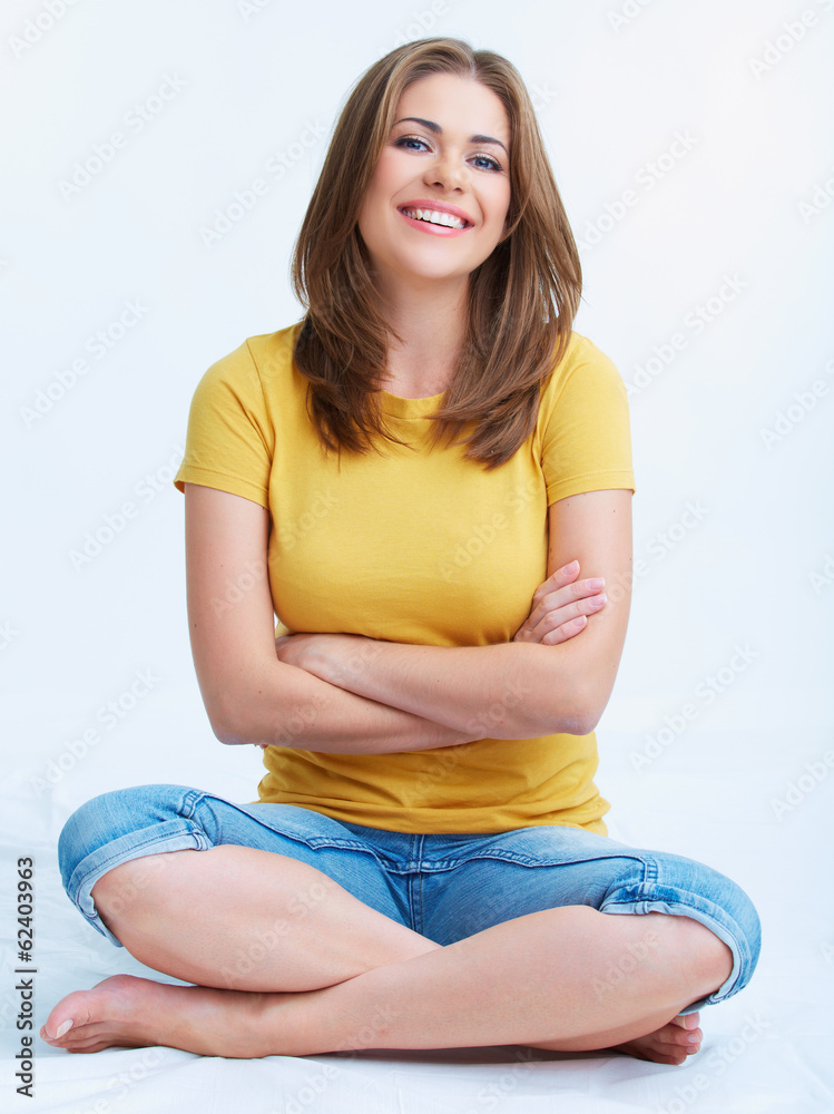 Portrait of smiling young woman seating on floor isolated. Portrait of smiling young woman seating on floor isolated.
