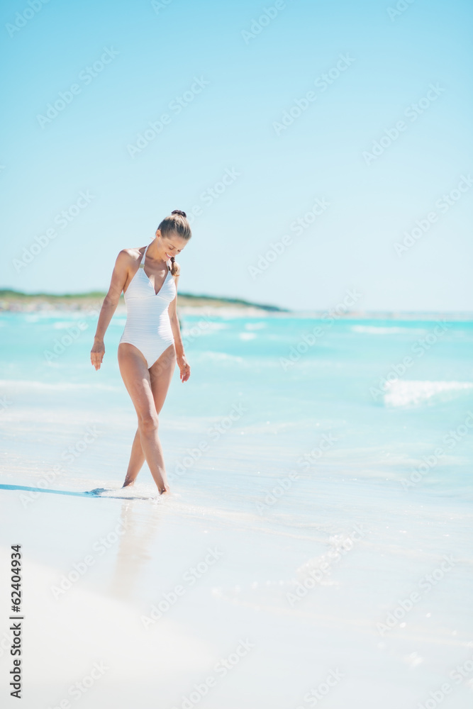 Young woman walking on sea coast