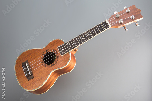 Ukulele guitar on gray background photo