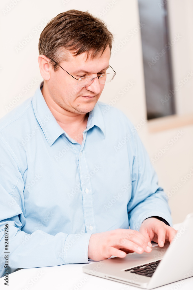 Middleaged man typing Middleaged man typing
