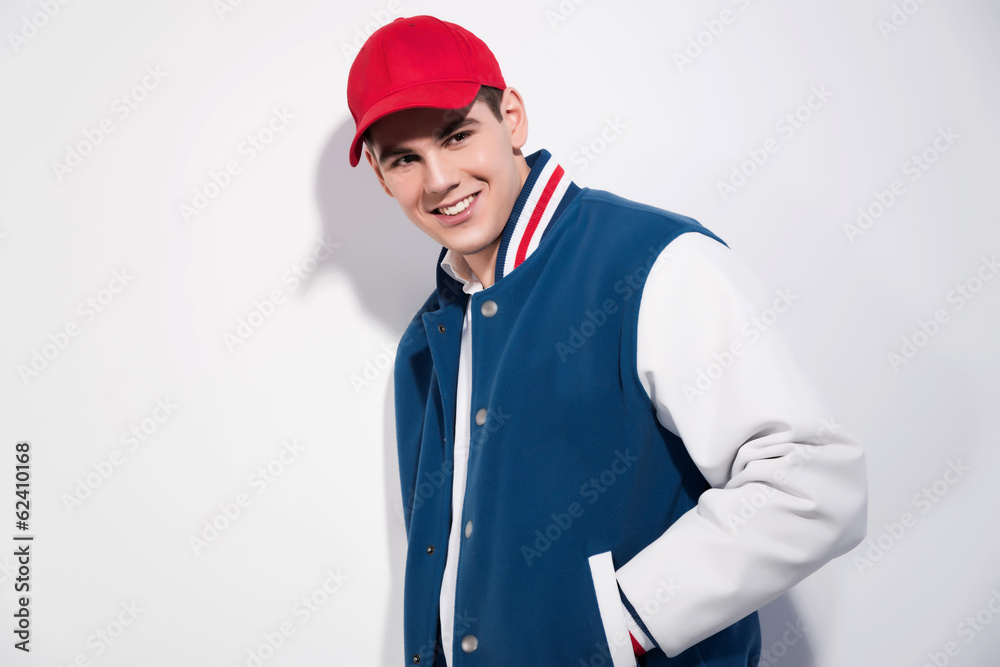 Smiling retro fifties sportive fashion man wearing blue baseball Smiling retro fifties sportive fashion man wearing blue baseball