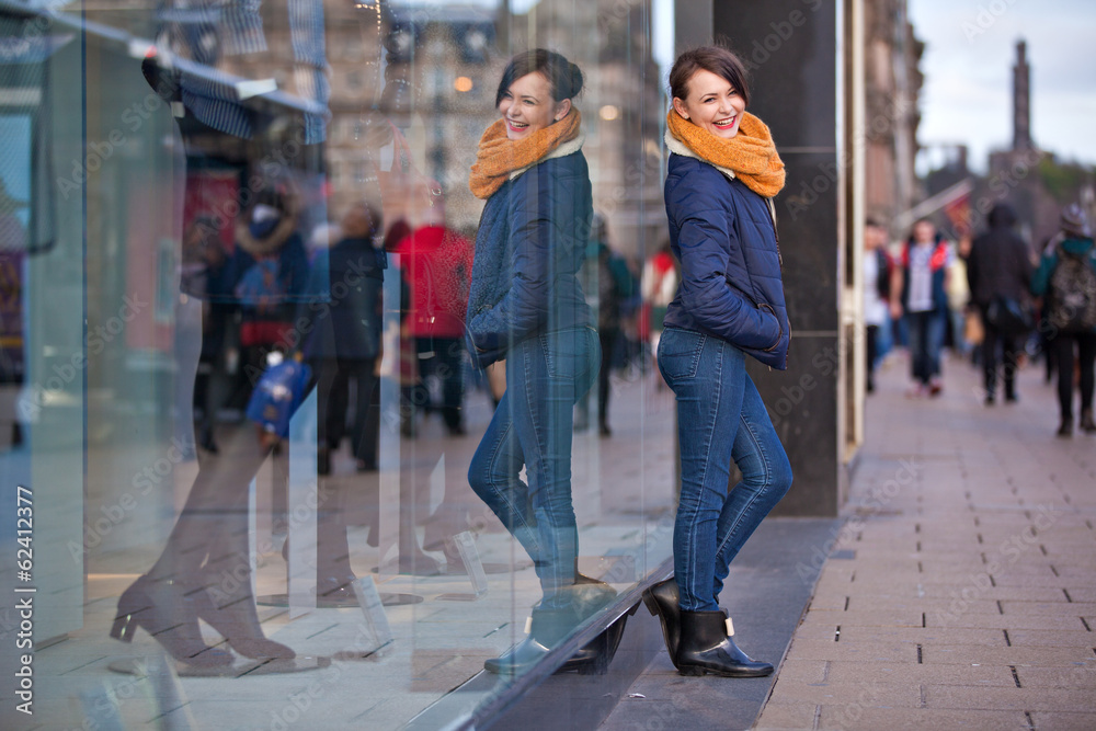 Pretty young girl standing at shopfront Pretty young girl standing at shopfront