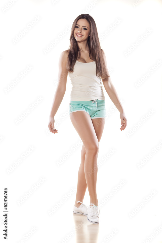pretty girl in shorts and shirt posing on white pretty girl in shorts and shirt posing on white