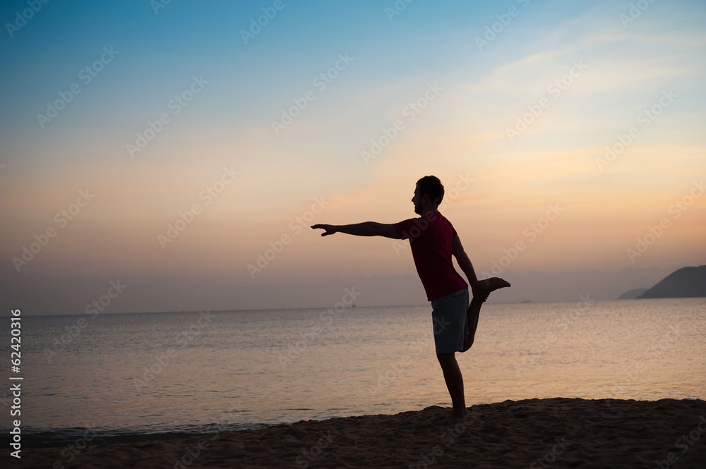 Silhouette of runner on the beach at sunset Silhouette of runner on the beach at sunset