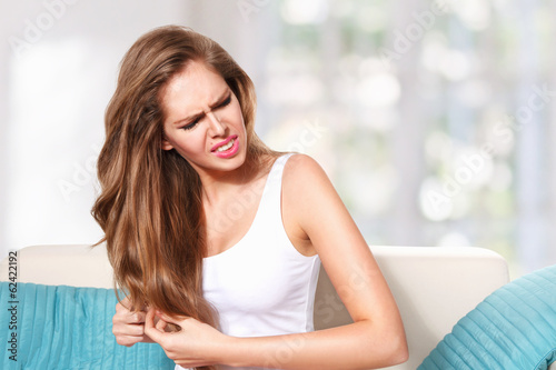 Tableau sur toile Beautiful young woman doing hair care at home