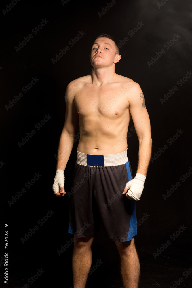 Fototapeta premium Young boxer breathing deeply before a fight