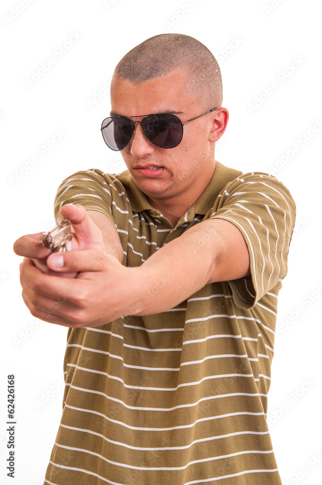 Fototapeta premium handsome young man pointing with toy gun against a white backgro
