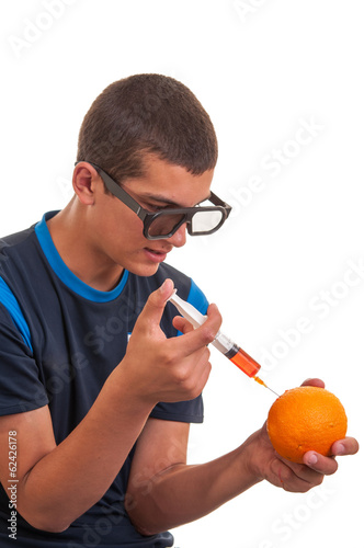 Young teen happy to do experiments with fruits for chemistry lab