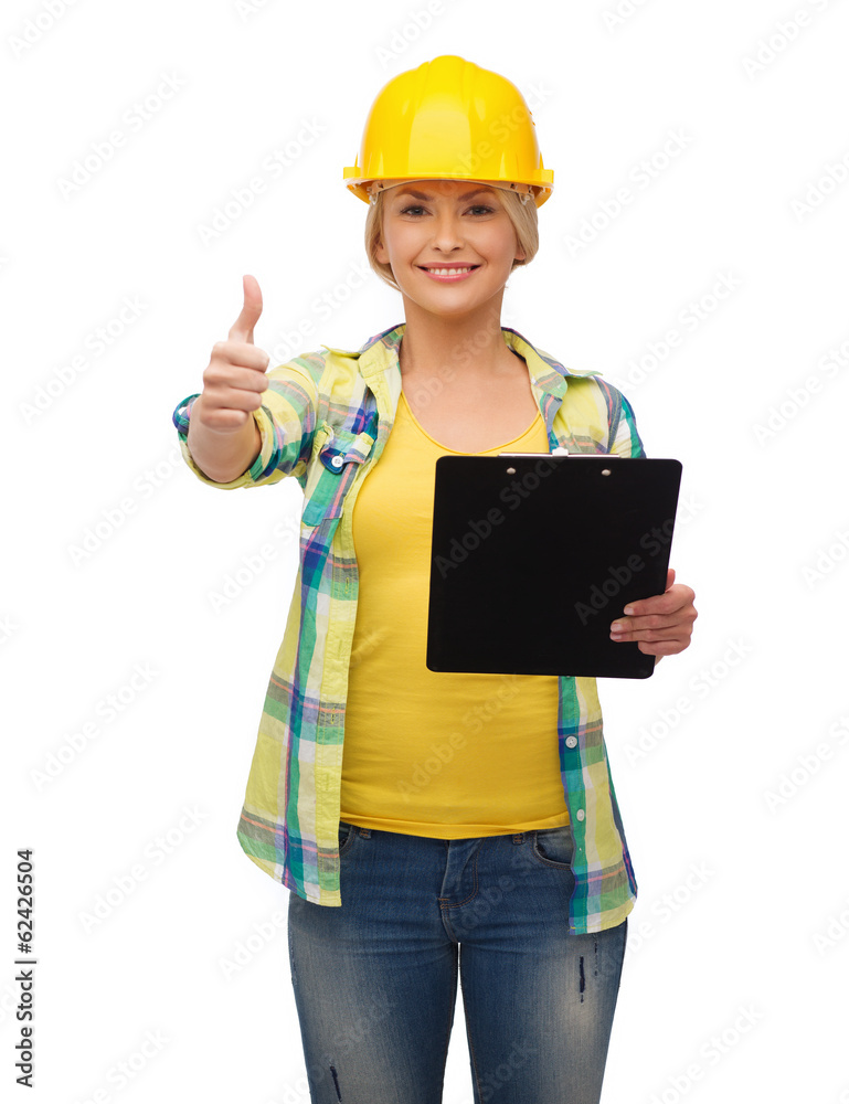 smiling woman in helmet with clipboard smiling woman in helmet with clipboard