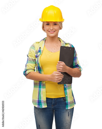 smiling woman in helmet with clipboard photo