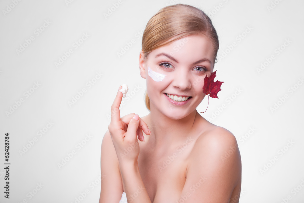 Skin care. Face of young woman girl with red maple leaf. Skin care. Face of young woman girl with red maple leaf.