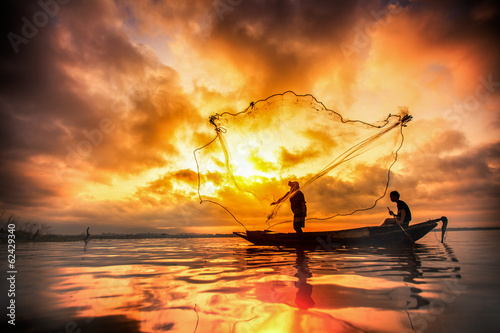 Fisherman of Bangpra Lake in action when fishing photo