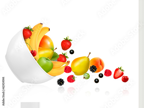 Fruit and berries falling from a bowl. Concept of healthy eating