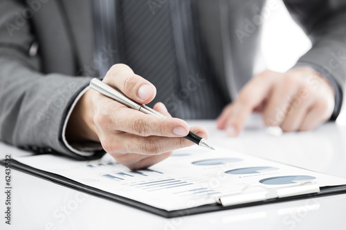 business report and man hand with pen